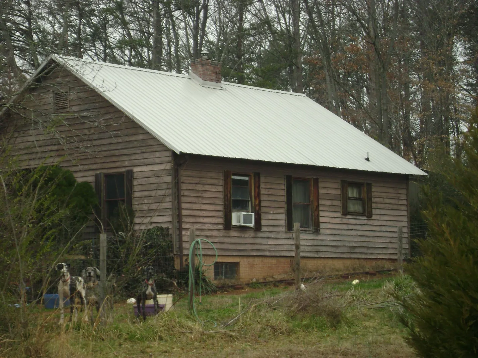 White metal roof on an old wood sided farmhouse, from a Metal Roof Installation job in North Hills